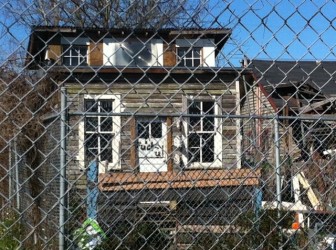 Vagrants dwell in a shack they have built on the property, neighbors say. 