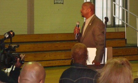 Former L.B. Landry football coach Derek LaMothe addresses the crowd at a public hearing on the Landry-Walker merger on Wednesday night.