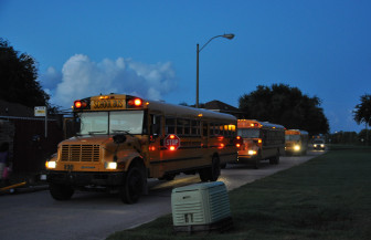 Three buses that pick up students for three different charter schools arrive at Michoud Boulevard and Adventure Avenue around 6:15 one morning.