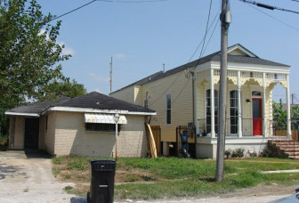 The more modern house on the left remains a blight on the neighborhood. Becnel hopes the city will demolish it. 