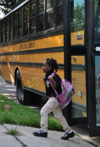 A student walks off the bus at John Dibert Community School, one of the many charter schools in New Orleans under the auspices of the Recovery School District.