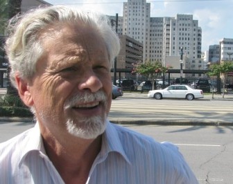 Standing on Canal Street, Pres Kabacoff describes his ideas to redevelop downtown New Orleans. The parking lot across the street would become a new mall to rival Lakeside Shopping Center. The old Charity Hospital, in the background, would be the home to City Hall, Civil District Court and a neuroscience research center.