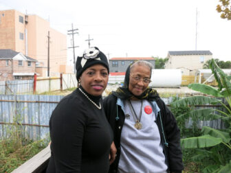 Marietta Ruffins, left, and neighbor Ruby Johnson can see the site of the proposed plant from Ruffins' back porch. 