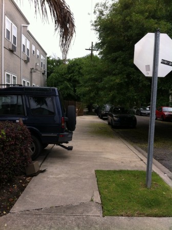 Unpermitted parking spaces at 4007 Prytania St. protrude out over the sidewalk. The building owner seeks a waiver to make them legal, years after they were created.