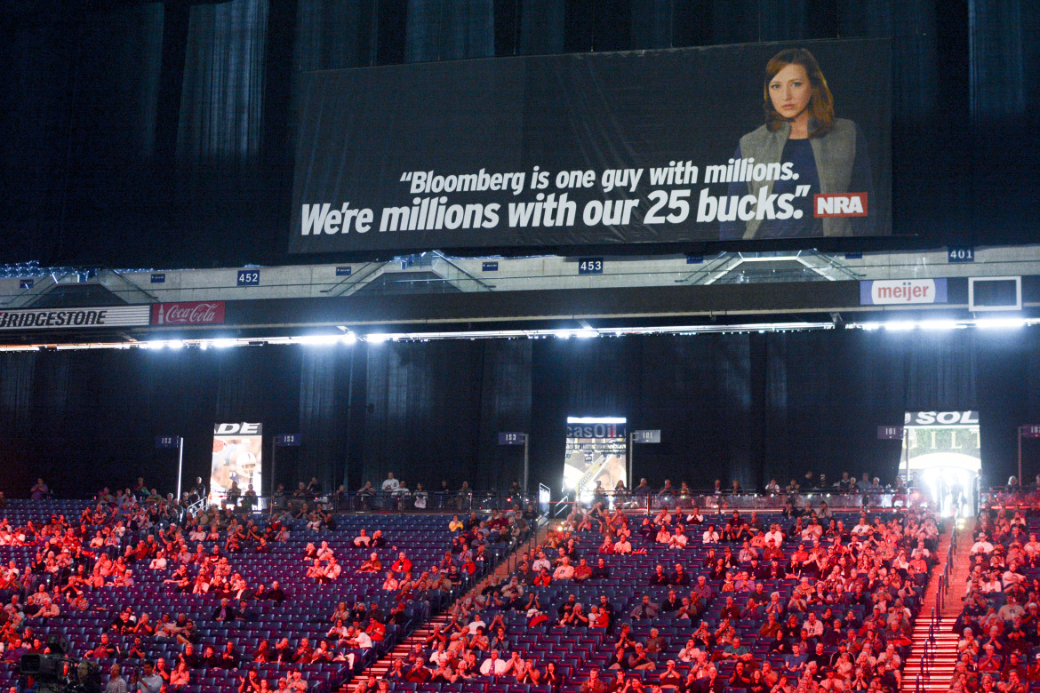 An NRA convention video labels Michael Bloomberg the group’s “enemy” given the former New York mayor’s million-dollar donations to gun control proponents. Posters echoing the message filled the Indianapolis venue. 