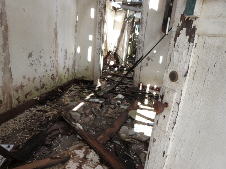 When The Lens visited his house in Hollygrove last week, the front door was open, revealing holes in the roof and second floor and a water-damaged first floor. The house is set to be torn down.
