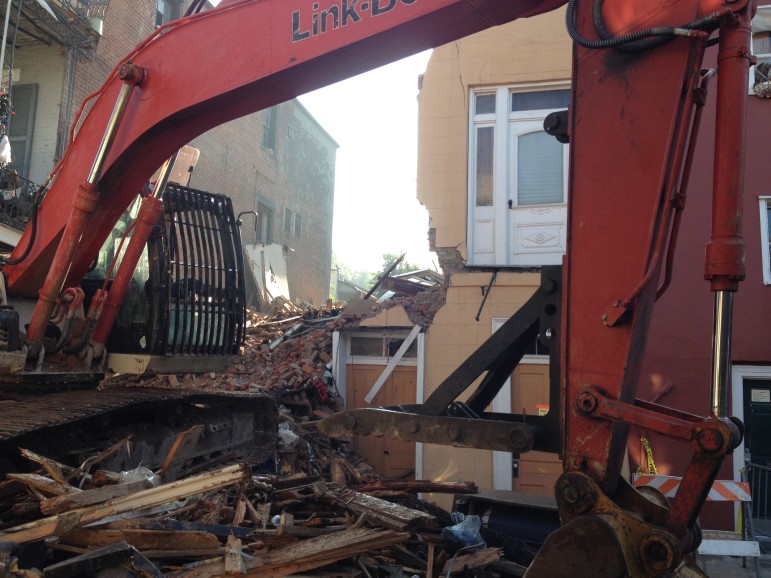 A bulldozer scrapes the lot at 810 Royal St. following collapse of a 200-year-old French Quarter building.