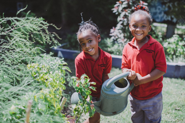Langston Hughes students Trinity Young and Kayla Watson get an up-close look at locally sourced food through the Edible Schoolyard program.