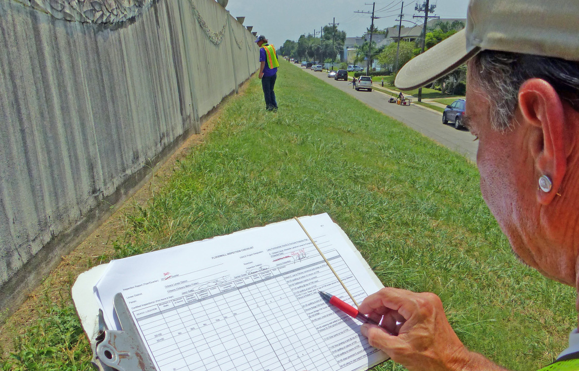 Johnny Holzenthal consults a checklist while walking the Orleans Outfall Canal during a quarterly inspection of the metro area's new hurricane protection system. Before Hurricane Katrina, local levee boards often ignored federal rules requiring regular inspections, but today the Southeast Louisiana Flood Protection Authority has 11 people doing checks full-time.