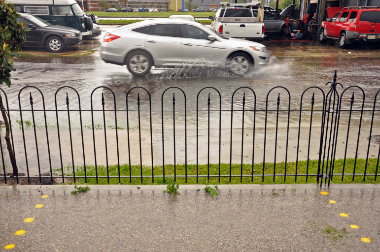 The parking lot at Parkway Bakery and Tavern stays dry as the nearby street takes on water in a recent storm.