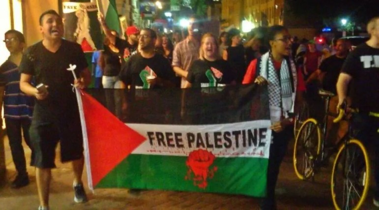 Area residents march in solidarity with Palestinians during the #astreetcarnamedgaza protest August 1, 2014, during Israel's Operation Protective Edge.