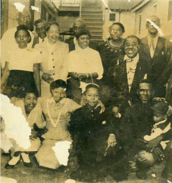 A rare photograph shows Armstrong, right, with members of his father's family, during a 1950 visit to Gert Town. 