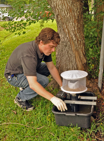 Brendan Carter of the New Orleans Mosquito, Termite and Rodent Control Board sets a mosquito trap in Gentilly. 