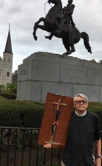 The Rev. Barnwell displays the African Jesus he carried in the march to Jackson Square. 