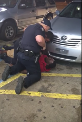 Baton Rouge police tackle CD street hawker Alton Sterling and prepare to open fire.