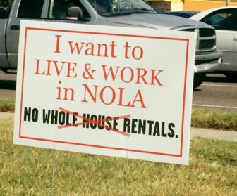 A yard sign links short-term, whole-house rentals to the lack of affordable housing in New Orleans.