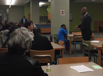 Orleans schools Superintendent Henderson Lewis Jr. speaks to parents and faculty at McDonogh 35 Senior High School. McDonogh 35's principal is one of five starting a new charter network that wants to take over the district's five remaining traditional schools.