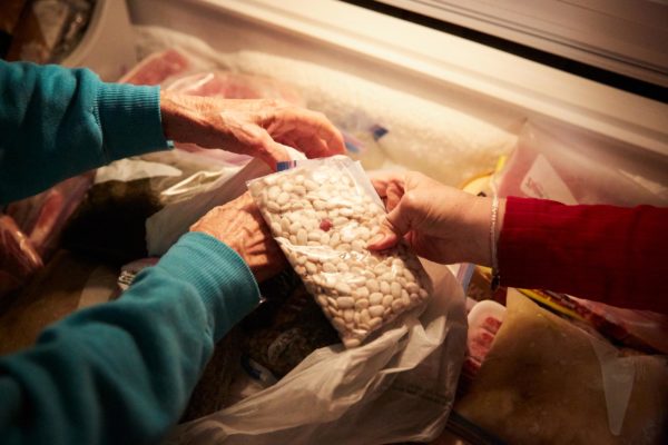 Nazia Dardar handles bags of beans and okra seeds from her freezer in Pointe-au-Chien.