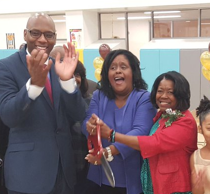 Moton CEO and Principal Paulette Bruno (center) cuts the ribbon for Moton’s new building with schools Superintendent Henderson Lewis Jr. (left) at a dedication ceremony in December 2016. Bruno has been fighting nepotism charges for five years.